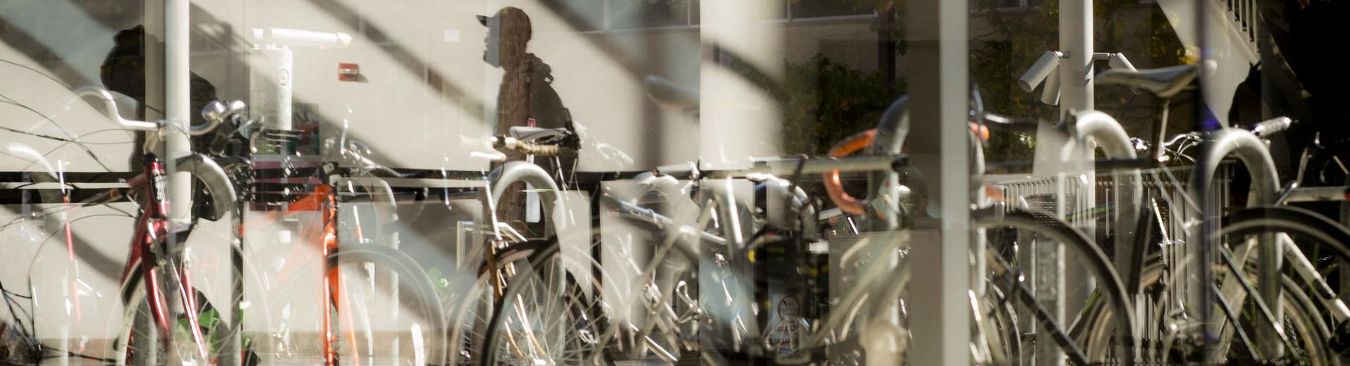 abstract image of bicycles parked outside a building on Main Campus. 