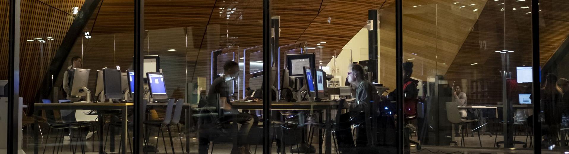 Students are studying at night in Charles Library